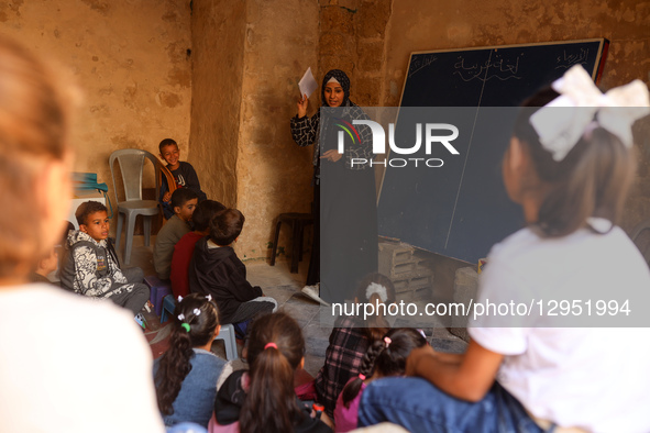 Palestinian children attend a class in the historic ''Al-Kamaliya al-Othmanya'' school in Gaza City's Old Town as part of a volunteer initia... by Majdi Fathi/NurPhoto