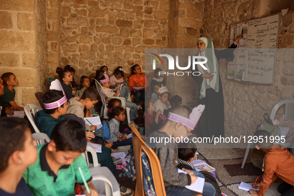Palestinian children attend a class in the historic ''Al-Kamaliya al-Othmanya'' school in Gaza City's Old Town as part of a volunteer initia... by Majdi Fathi/NurPhoto