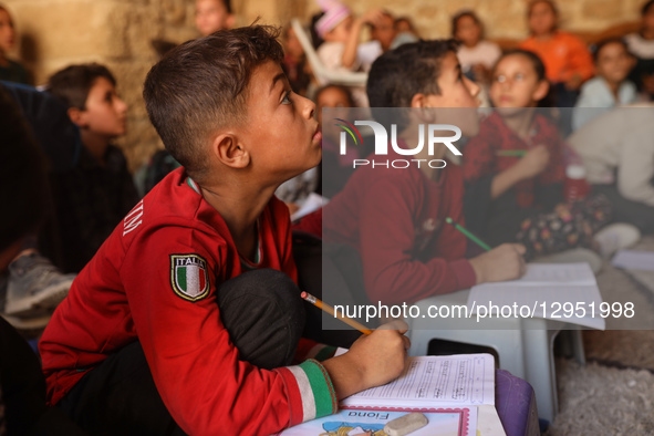 Palestinian children attend a class in the historic ''Al-Kamaliya al-Othmanya'' school in Gaza City's Old Town as part of a volunteer initia...