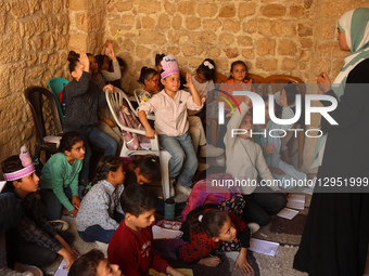 Palestinian children attend a class in the historic ''Al-Kamaliya al-Othmanya'' school in Gaza City's Old Town as part of a volunteer initia... by Majdi Fathi/NurPhoto