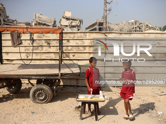 Palestinians walk amid the rubble of destroyed buildings in Gaza City, Palestine, on November 5, 2025, during a ceasefire in the two-year-lo... by Majdi Fathi/NurPhoto