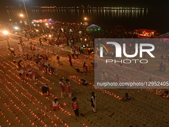 Devotees light traditional oil lamps as they celebrate the Hindu festival of 'Dev Deepawali' at Sangam, the confluence of the rivers Ganges,... by Sanjay Kanojia/NurPhoto