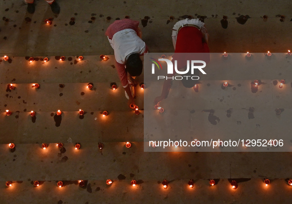 Devotees light traditional oil lamps as they celebrate the Hindu festival of 'Dev Deepawali' at Sangam, the confluence of the rivers Ganges,... by Sanjay Kanojia/NurPhoto