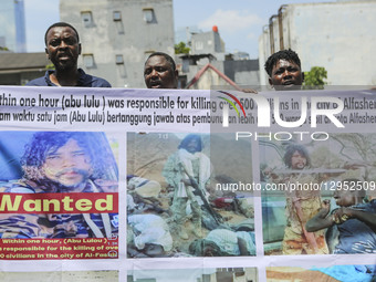 Sudanese refugees gather in front of the United Nations High Commissioner for Refugees (UNHCR) office in Jakarta, Indonesia, on November 3,... by Agoes Rudianto/NurPhoto