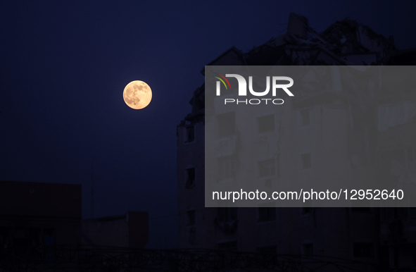 The full moon rises above a destroyed building in Gaza City, on November 5, 2025.  by Majdi Fathi/NurPhoto