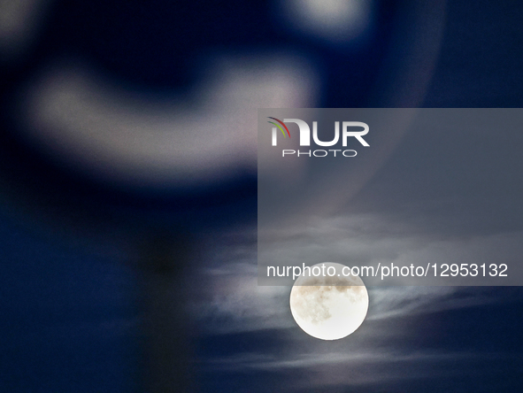 The Beaver Moon rises behind urban neighbourhood as the sun sets in Krakow, Poland on November 4, 2025.  by Dominika Zarzycka/NurPhoto