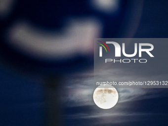 The Beaver Moon rises behind urban neighbourhood as the sun sets in Krakow, Poland on November 4, 2025.  by Dominika Zarzycka/NurPhoto