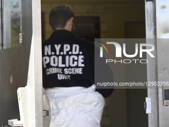 Members of the NYPD crime scene unit, police officers, and detectives, including the medical examiner's office, work the crime scene where f... by Kyle Mazza/NurPhoto