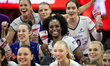 Taylor Bannister and her teammates celebrate winning the cup after the volleyball match be...
