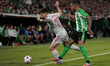 Natan Bernardo de Souza of Real Betis competes for the ball with Martin Satriano of Olympi...