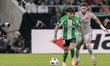 Ez Abde of Real Betis competes for the ball with Tanner Tessmann of Olympique de Lyon duri...