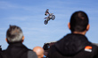 Riders perform during a freestyle show at Motolive Arena on the first day of opening to th...