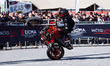 Riders perform during a freestyle show at Motolive Arena on the first day of opening to th...