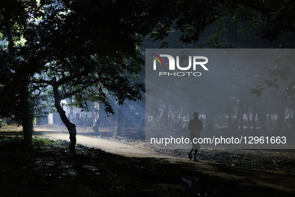 People walk through a park at night in Dhaka, Bangladesh, on November 7, 2025.  by Syed Mahamudur Rahman/NurPhoto
