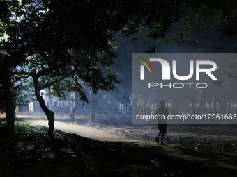 People walk through a park at night in Dhaka, Bangladesh, on November 7, 2025.  by Syed Mahamudur Rahman/NurPhoto