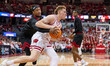 Wisconsin Badgers forward Austin Rapp (22) drives the baseline past a Northern Illinois Hu...