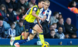 Filip Krastev of Oxford United and Alfie Gilchrist of West Bromwich Albion are in action d...