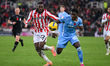 Junior Tchamadeu of Stoke City and Ephron Mason-Clark of Coventry City compete for the bal...