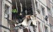 Rescuers work at an apartment block hit by a Russian drone in Dnipro, Ukraine, on November...