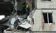 Rescuers work at an apartment block hit by a Russian drone in Dnipro, Ukraine, on November...