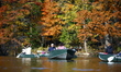 Tourists and visitors sail in boats on the Central Park lake amid the golden and reddish r...