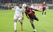 Pervis Estupinan of AC Milan battles for the ball with Sascha Britschgi of Parma AC during...