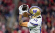 Washington Huskies wide receiver Denzel Boston (12) catches a pass against the Wisconsin B...
