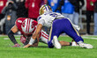 Wisconsin Badgers linebacker Mason Posa (8) causes a fumble by Washington Huskies quarterb...
