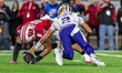 Wisconsin Badgers linebacker Mason Posa (8) causes a fumble by Washington Huskies quarterb...