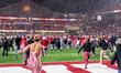 Fans rush the field after Wisconsin's 13-10 win over the Washington Huskies at Camp Randal...