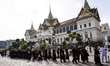Thai people walk in line to enter the Throne Hall at the Grand Palace for the first time t...