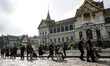 Thai people walk in line to enter the Throne Hall at the Grand Palace for the first time t...
