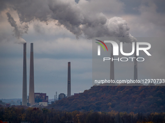 Pollution and steam rise from the stacks of the Miami Fort Power Station, which is situated along the Ohio River near Cincinnati, Ohio, on N... by Jason Whitman/NurPhoto