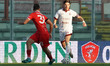 Emiliano Patterello of SS Arezzo and Linas Magelaits of AC Perugia Calcio compete for the...