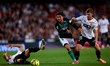 Pablo Fornals of Real Betis Balompie competes for the ball with Lucas Beltran of Valencia...