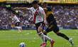 Maximiliano Salas of River Plate competes for the ball with Ayrton Costa of Boca Juniors d...