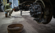 A worker restores a military vehicle in a repair shop of one of the military logistical su...