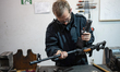A worker restores a rifle in a repair shop of one of the military logistical support units...