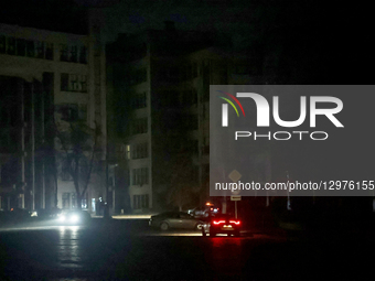 Cars move along a street near the Derzhprom building in complete darkness in Kharkiv, Ukraine, on November 8, 2025. Dozens of streets and ne... by Viacheslav Madiievskyi/Ukrinform/NurPhoto