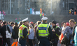 Police are seen as carnival revelers celebrate the opening of Carnival in front of Cologne...