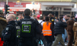 Police observe the crowd as carnival revelers celebrate the opening of Carnival in Zulpich...