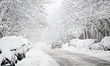 A car is on a snow-covered street in Montreal, Quebec, Canada, on November 11, 2025, as th...