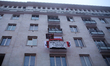 In Warsaw, Poland, on November 11, 2025, a balcony displays a banner reading 'True patriot...