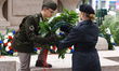 Members of the armed forces carry wreaths honoring veterans during a ceremony in New York...