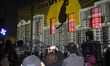 Iranian youths capture videos as a digital video-mapping artwork created by AI software is...