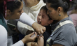 Medical personnel attend to children outside the Olympic Stadium of the National Autonomou...