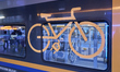 A close-up of the bicycle symbol is inside a Trenitalia regional train carriage with dedic...