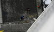 Municipal workers remove debris outside a tower block in the Dniprovskyi district damaged...
