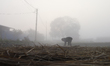 A Nepali farmer arranges stacks of hay in his field in Lalitpur, Nepal, on November 16, 20...
