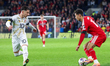 Brennan Johnson of Wales is on the ball as Enis Bardhi of North Macedonia races to interce...